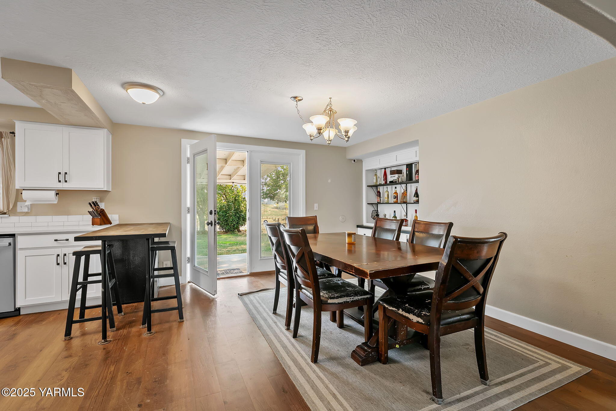 8351 North Wenas Road Selah, WA 98942 - Photo 16 of 26 a view of a dining room with furniture window and wooden floor