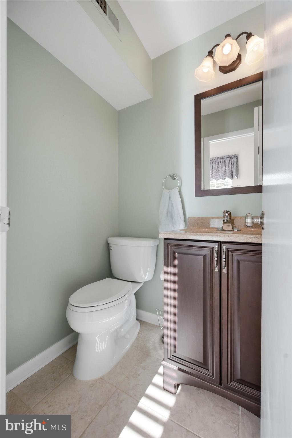 1965 Foster Road Hatfield, PA 19440 - Photo 14 of 38 a bathroom with a toilet sink vanity and mirror