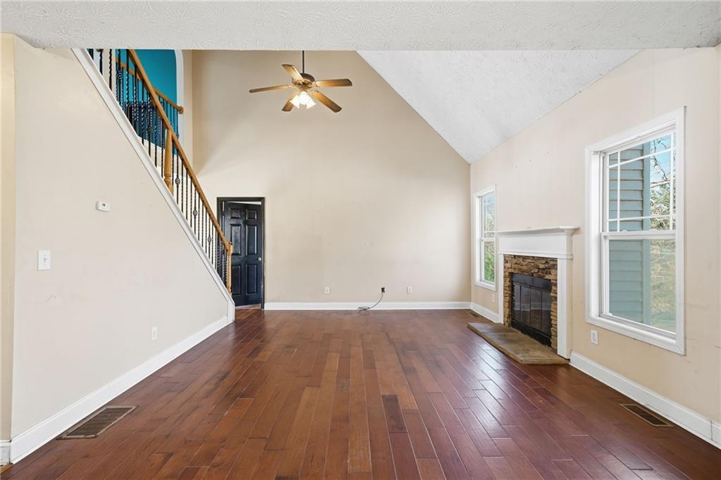 27 Larsen Ridge Adairsville, GA 30103 - Photo 11 of 47 a view of a livingroom with wooden floor and staircase