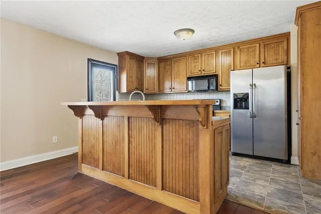 a kitchen with stainless steel appliances a refrigerator and a stove