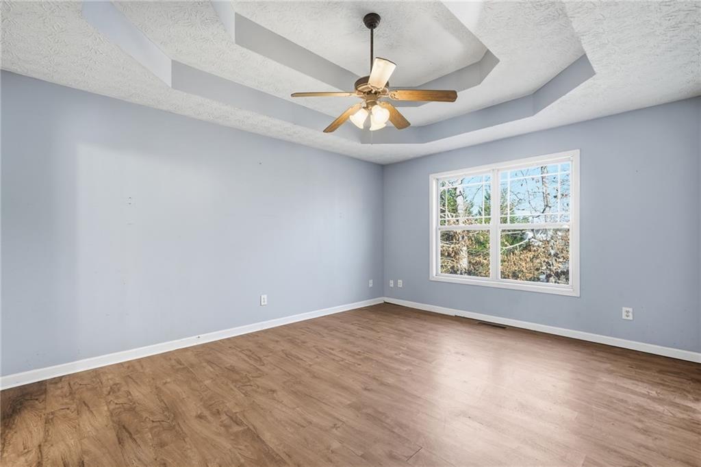 27 Larsen Ridge Adairsville, GA 30103 - Photo 17 of 47 an empty room with wooden floor fan and windows
