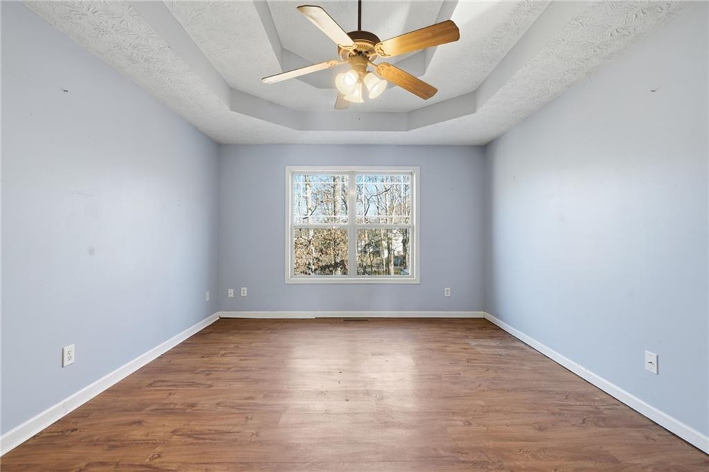 27 Larsen Ridge Adairsville, GA 30103 - Photo 18 of 47 an empty room with a window and a chandelier fan