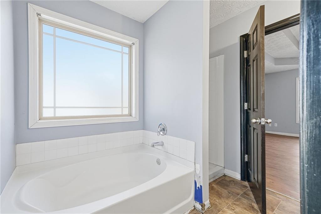 27 Larsen Ridge Adairsville, GA 30103 - Photo 21 of 47 a white bath tub sitting next to a shower