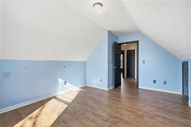 a view of a room with wooden floor