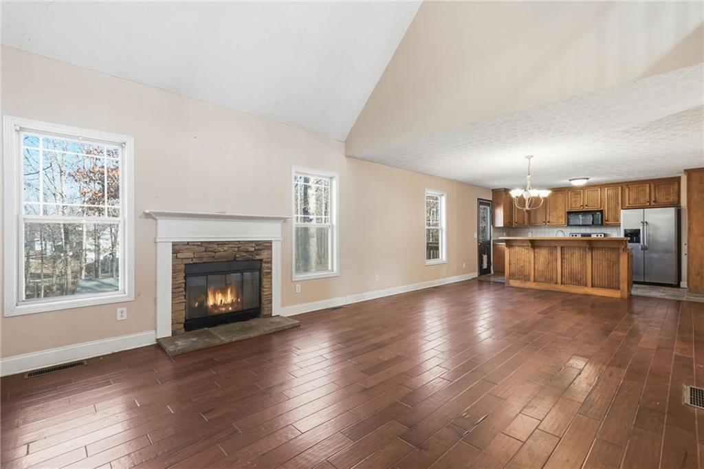 27 Larsen Ridge Adairsville, GA 30103 - Photo 7 of 47 a view of a livingroom with furniture wooden floor fire place and windows