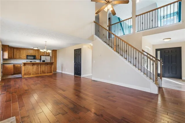 a view of a kitchen with wooden floor and electronic appliances