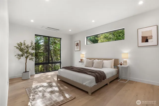 a bedroom with a bed and a potted plant