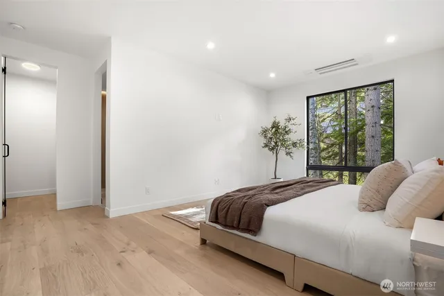 a bedroom with a large bed and a large window