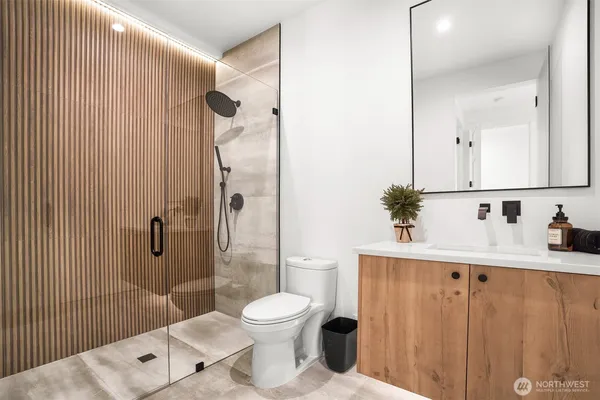 a bathroom with a toilet a sink and shower
