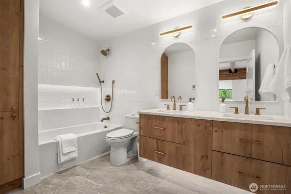 a bathroom with a toilet sink and mirror