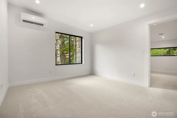 an empty room with windows and closet