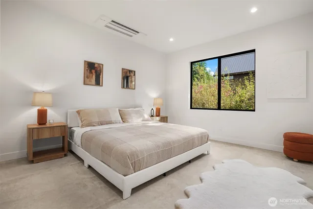 a bedroom with a bed and a painting