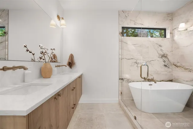 a bathroom with a tub sink and mirror