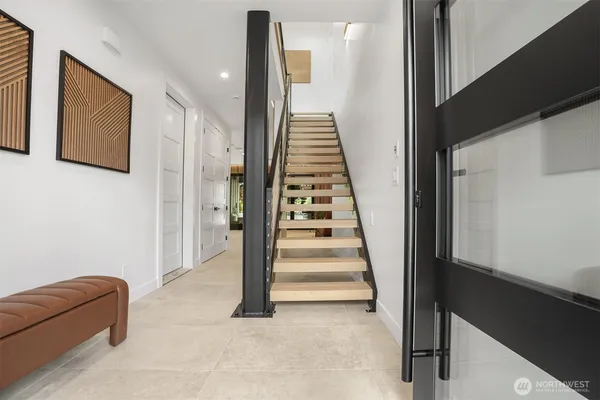 a view of entryway and hall with wooden floor