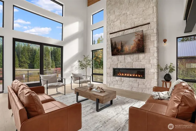 a living room with furniture large window and a fireplace