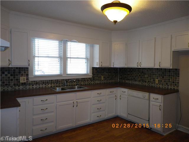 3372 Country Club Road Winston-Salem, NC 27104 - Photo 7 of 16 Kitchen. Kitchen has tile backsplash and freshly painted cabinets!