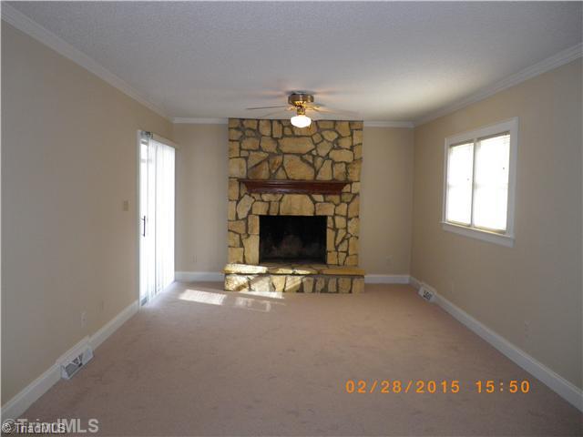 3372 Country Club Road Winston-Salem, NC 27104 - Photo 10 of 16 Den/Family/Great Room. Den with stone fireplace and sliding glass doors that open to covered patio.