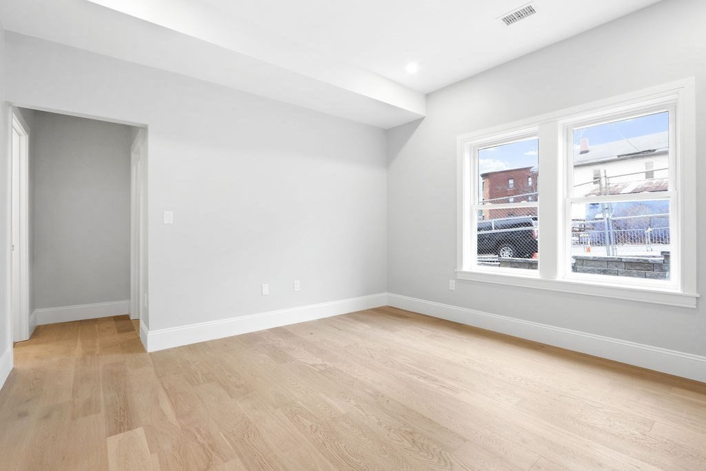 21 Glen Road, Unit 1 Boston, MA 02130 - Photo 4 of 10 a view of an empty room with a window