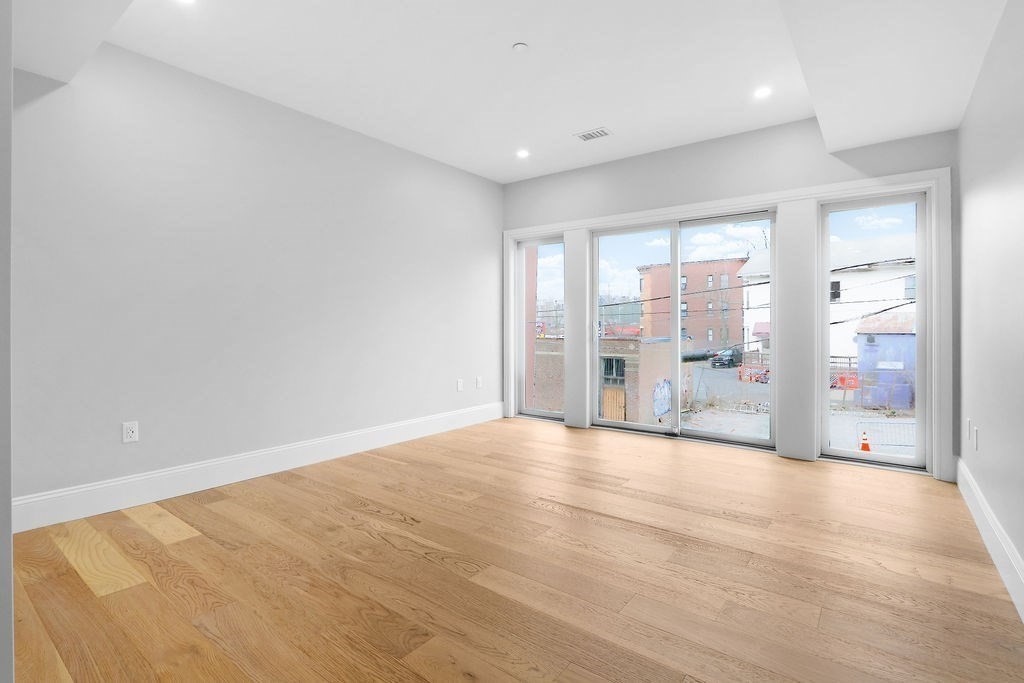 21 Glen Road, Unit 1 Boston, MA 02130 - Photo 10 of 10 a view of an empty room with a window