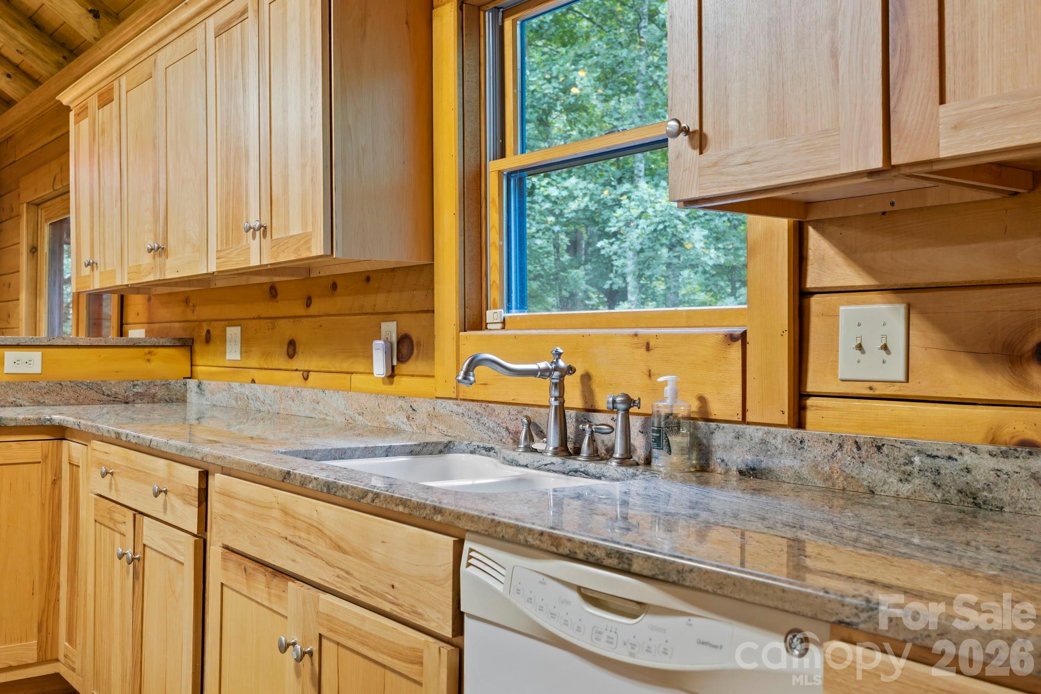 266 Rhododendron Drive Saluda, NC 28773 - Photo 12 of 35 a kitchen with stainless steel appliances granite countertop a sink and a window