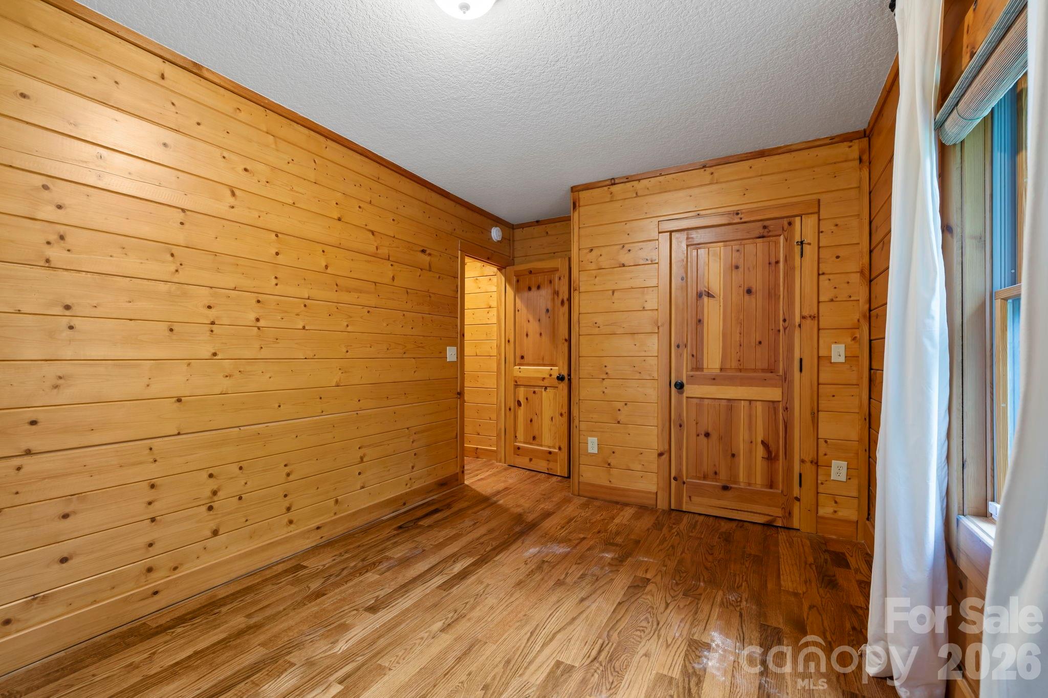 266 Rhododendron Drive Saluda, NC 28773 - Photo 18 of 35 a view of empty room with wooden floor and cabinet