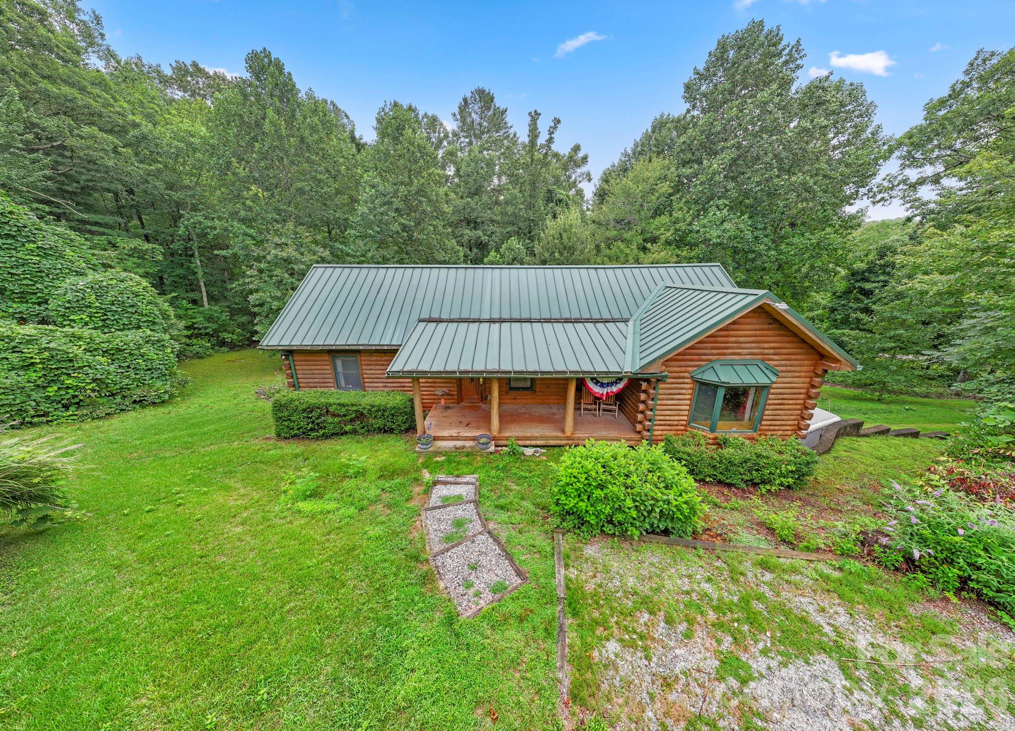 266 Rhododendron Drive Saluda, NC 28773 - Photo 2 of 35 a view of a house with a yard and tree s