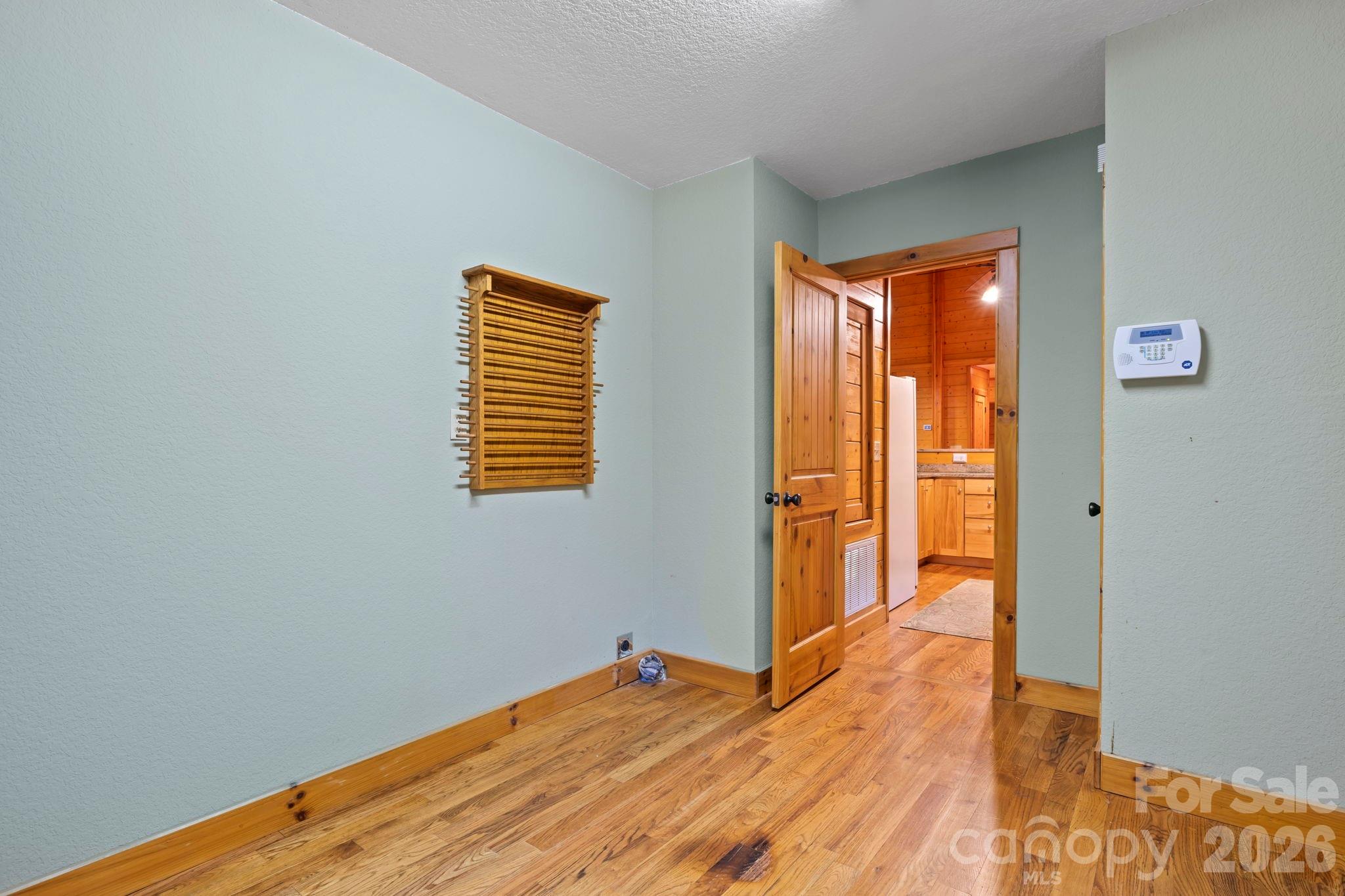 266 Rhododendron Drive Saluda, NC 28773 - Photo 22 of 35 a view of empty room with wooden floor and fan
