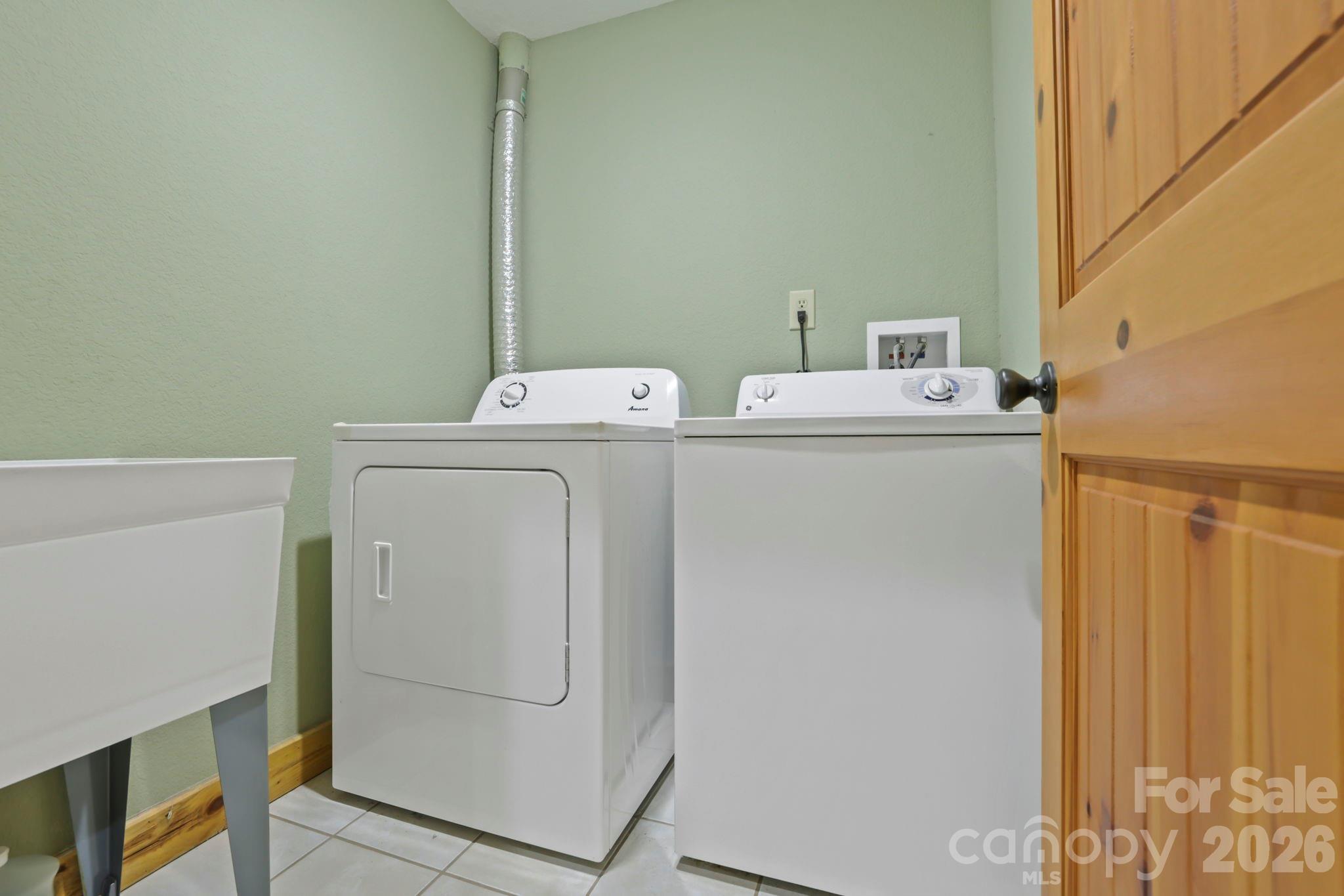 266 Rhododendron Drive Saluda, NC 28773 - Photo 29 of 35 a utility room with dryer and washer