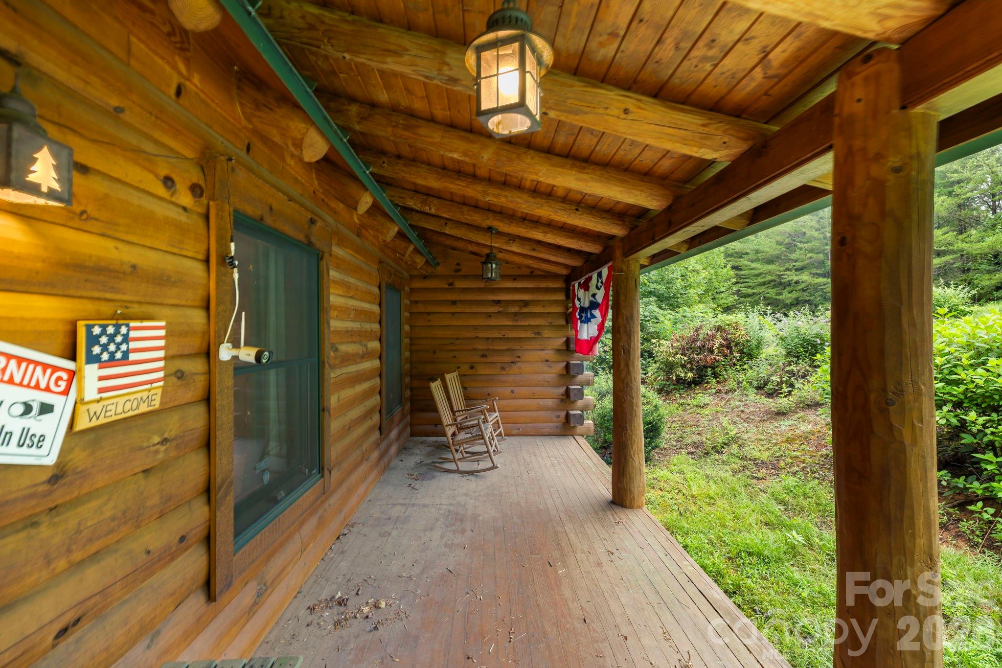 266 Rhododendron Drive Saluda, NC 28773 - Photo 31 of 35 a view of porch with a table and chairs