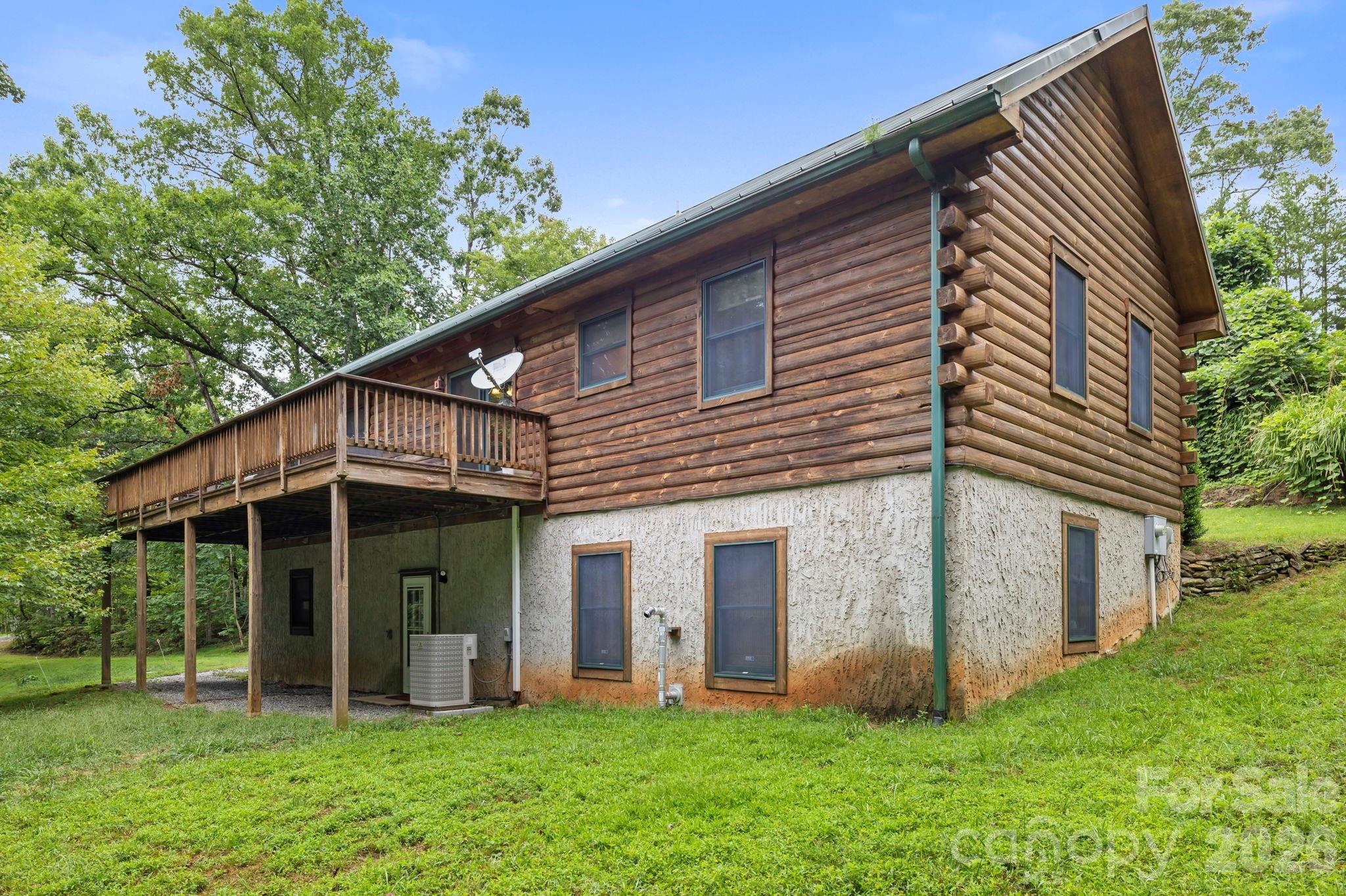 266 Rhododendron Drive Saluda, NC 28773 - Photo 4 of 35 a front view of a house with a yard and porch