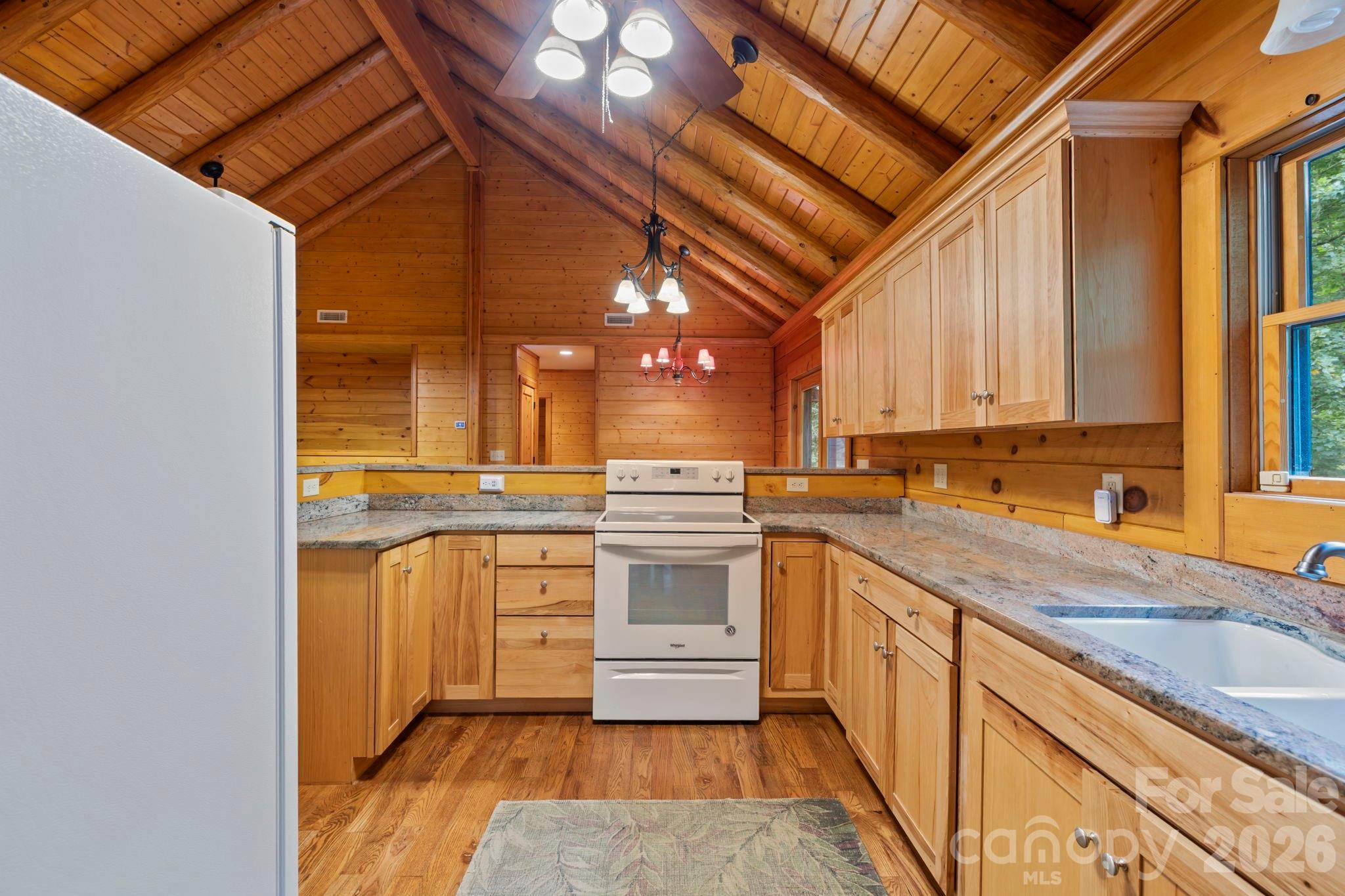 266 Rhododendron Drive Saluda, NC 28773 - Photo 10 of 35 a kitchen with stainless steel appliances granite countertop a sink and cabinets
