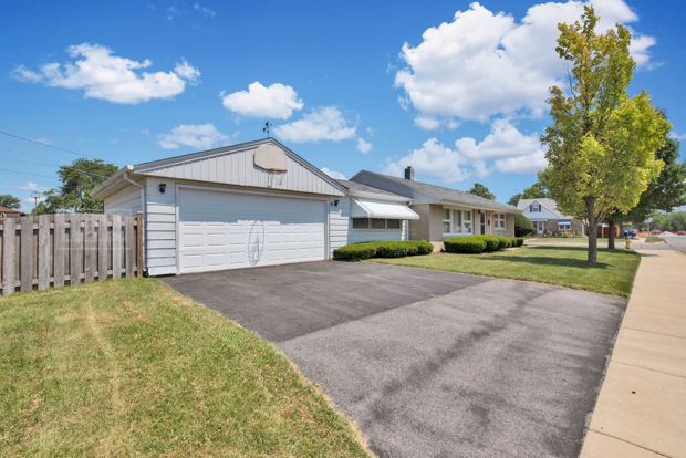 4346 Maple Avenue Brookfield, IL 60513 - Photo 2 of 18 a front view of a house with a yard and garage