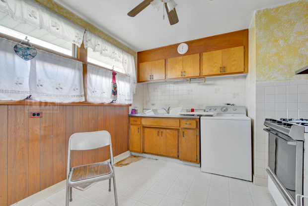 4346 Maple Avenue Brookfield, IL 60513 - Photo 6 of 18 a kitchen with granite countertop a sink cabinets stainless steel appliances and a counter top space