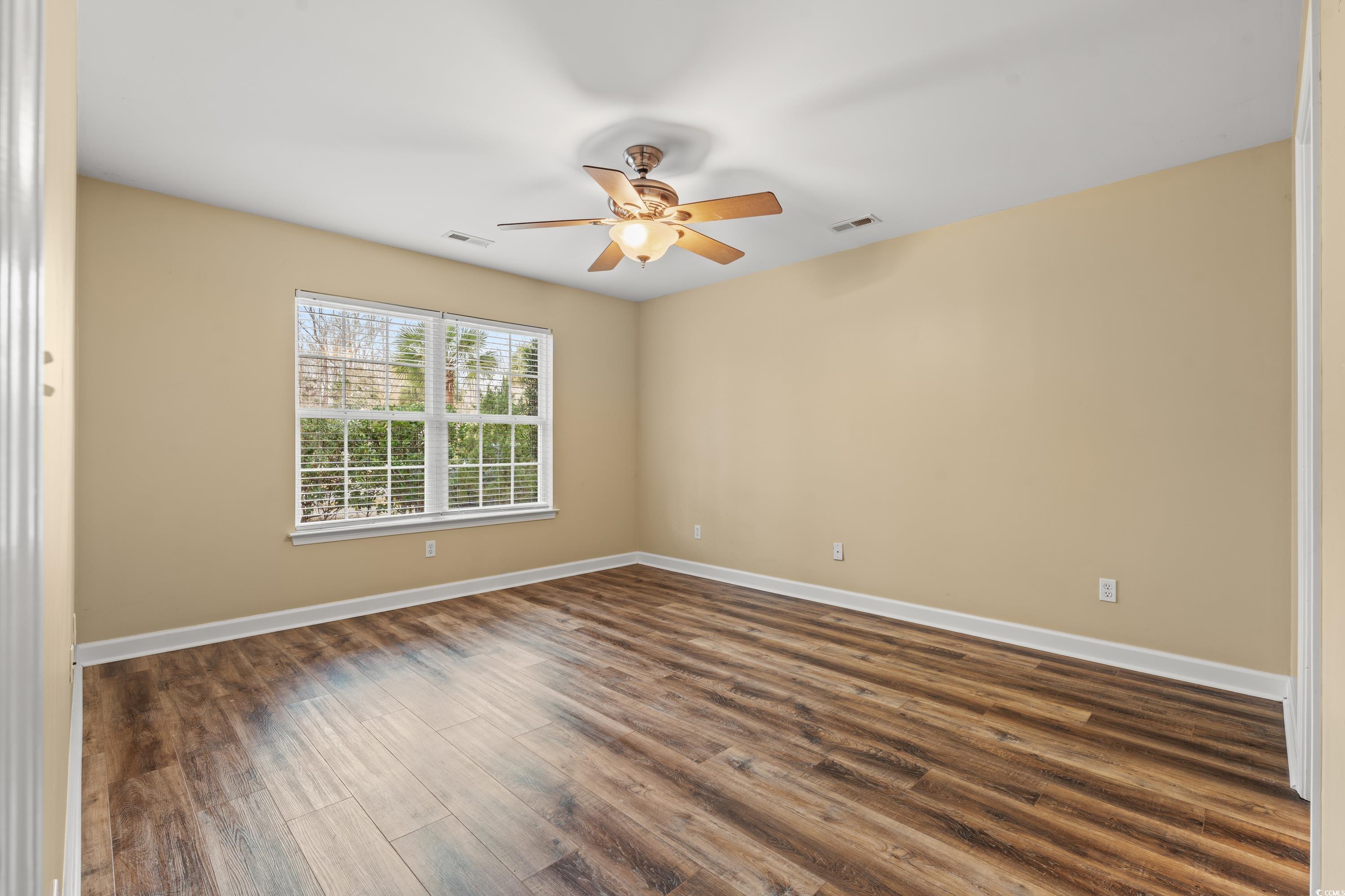 177 Reef Run Road Pawleys Island, SC 29585 - Photo 11 of 40 Spare room with a ceiling fan, dark wood-style flo