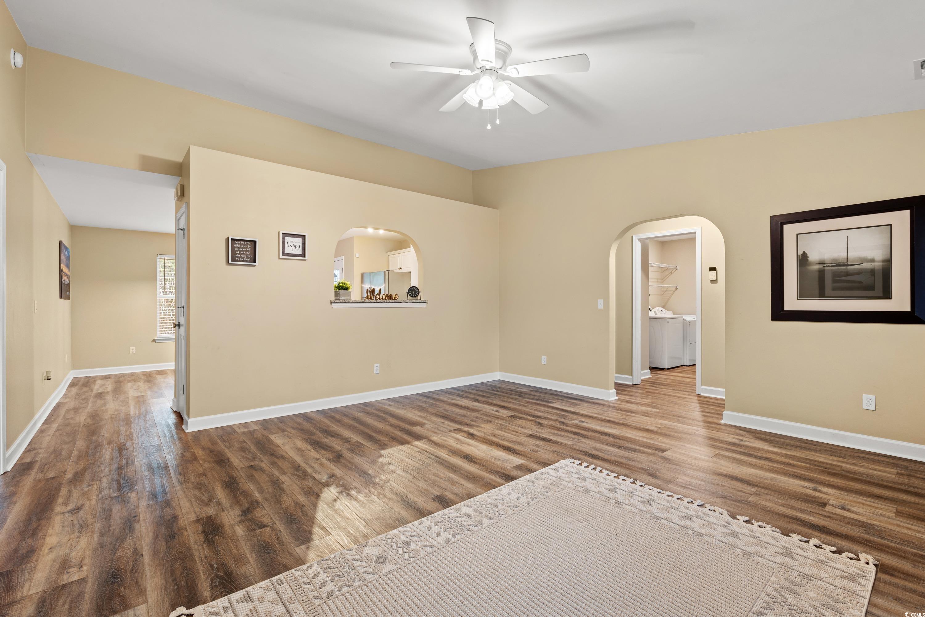 177 Reef Run Road Pawleys Island, SC 29585 - Photo 15 of 40 Empty room featuring arched walkways, washing mach