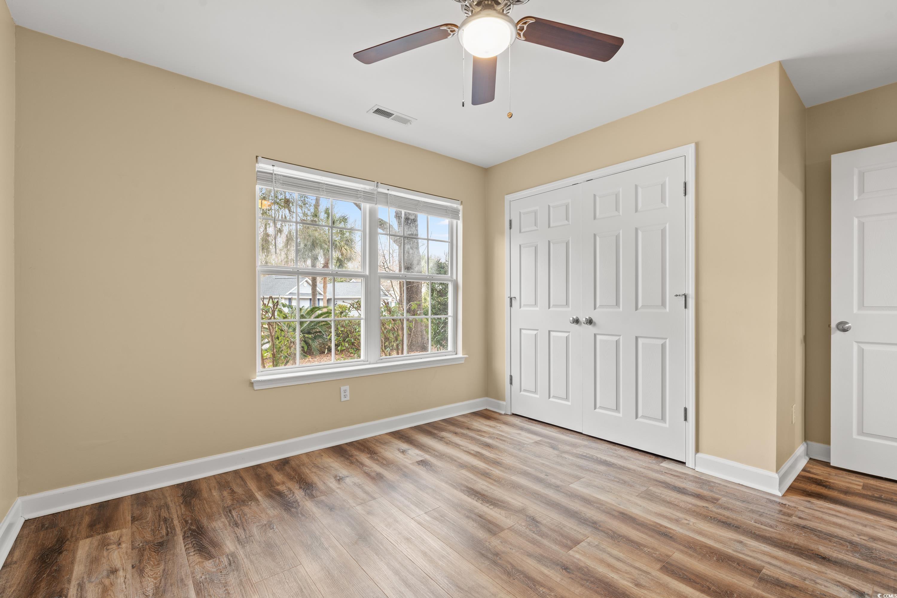 177 Reef Run Road Pawleys Island, SC 29585 - Photo 17 of 40 Unfurnished bedroom featuring ceiling fan, wood fi