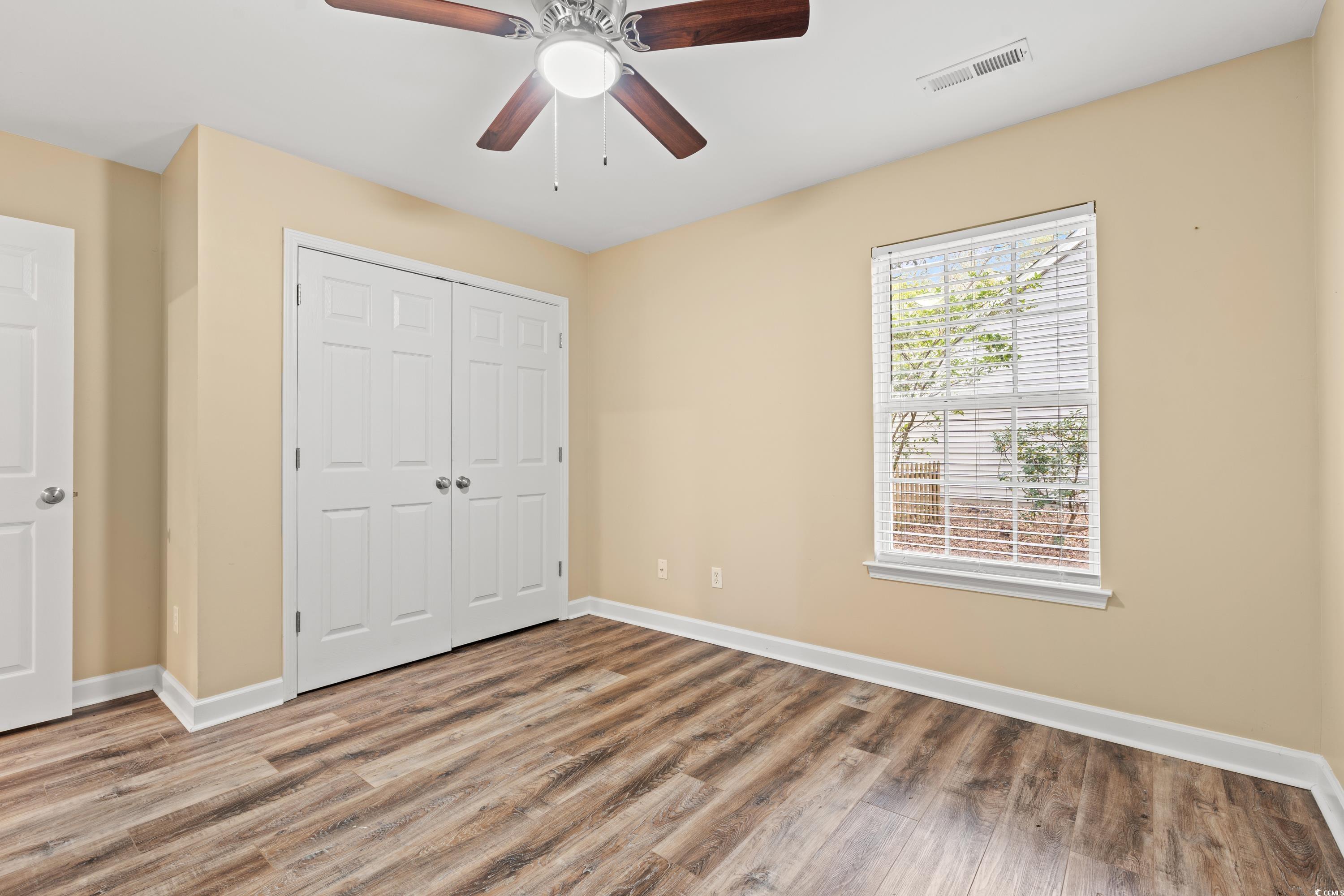 177 Reef Run Road Pawleys Island, SC 29585 - Photo 22 of 40 Unfurnished bedroom with a closet, wood finished f
