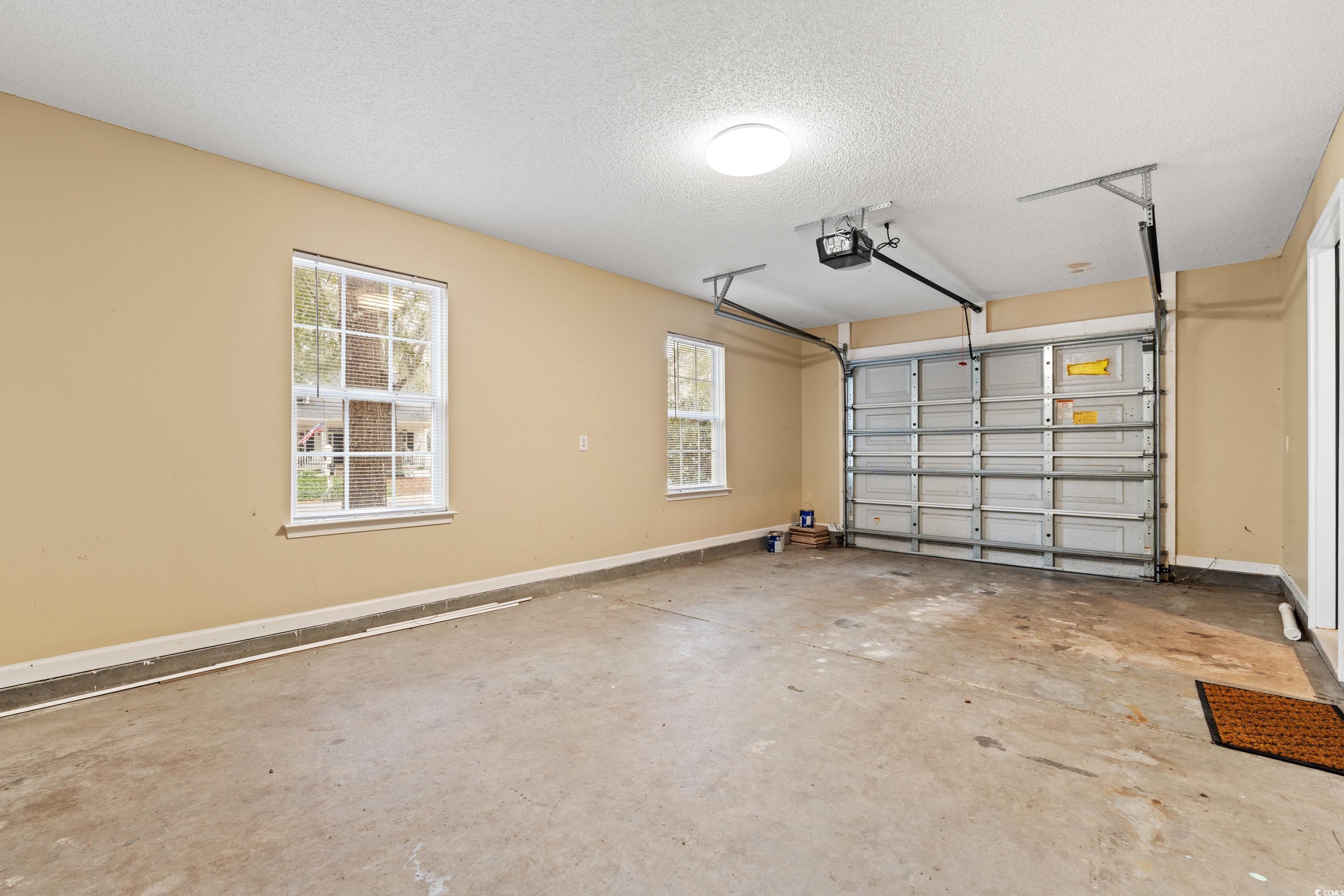 177 Reef Run Road Pawleys Island, SC 29585 - Photo 26 of 40 Garage with baseboards and a garage door opener
