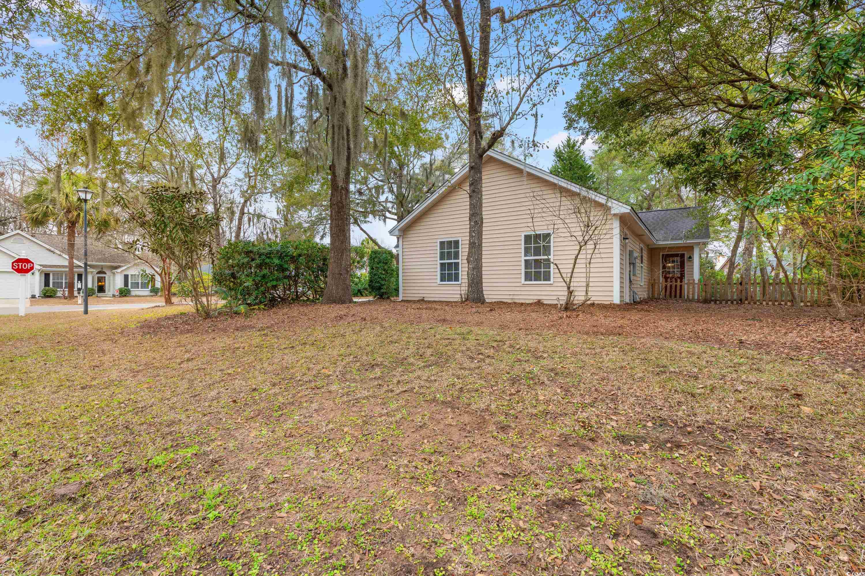 177 Reef Run Road Pawleys Island, SC 29585 - Photo 30 of 40 View of home's exterior featuring fence and a yard