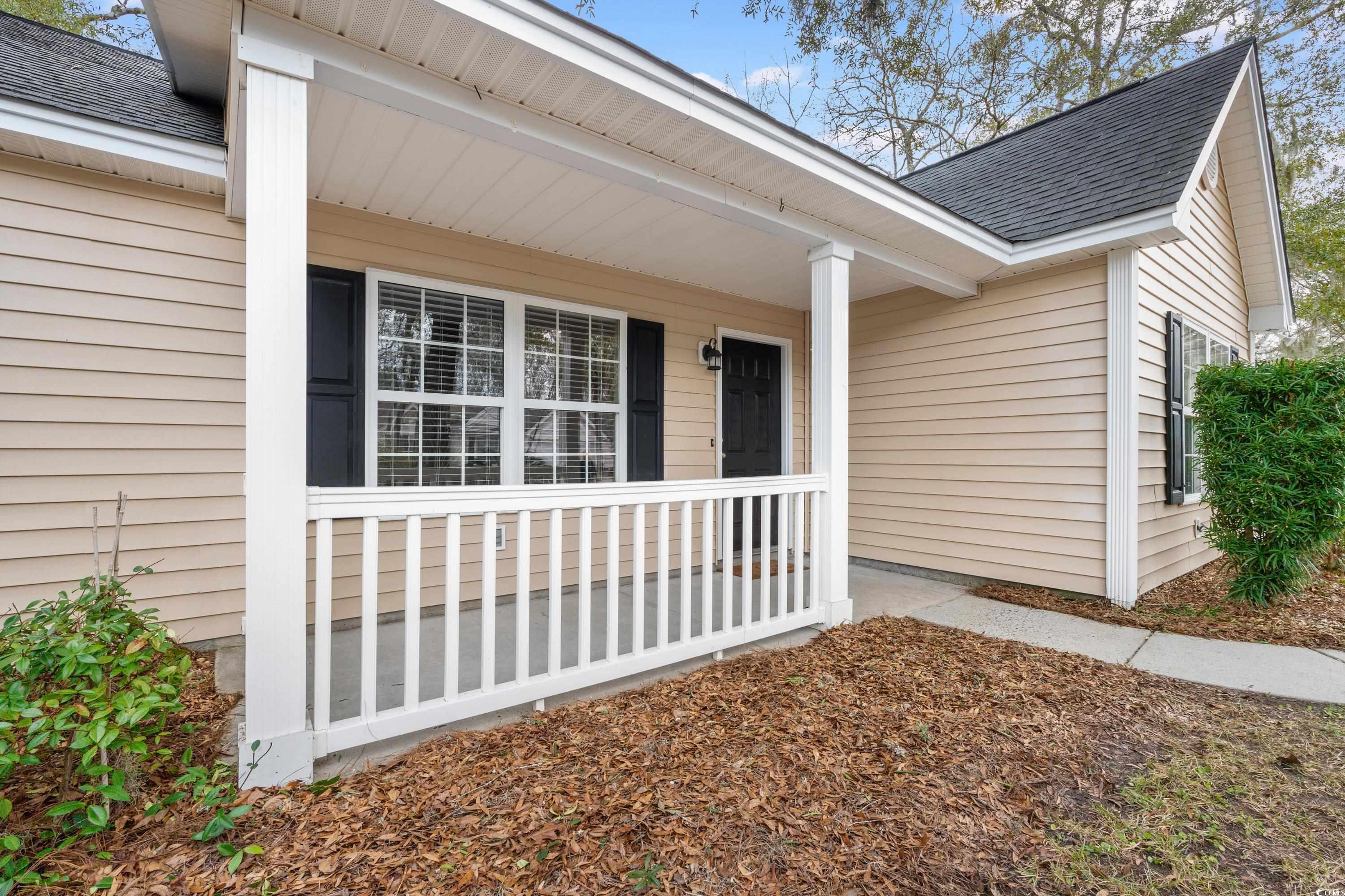 177 Reef Run Road Pawleys Island, SC 29585 - Photo 33 of 40 View of exterior entry with a shingled roof and a