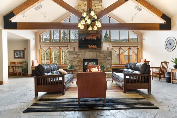 a living room with furniture a fireplace and a large window
