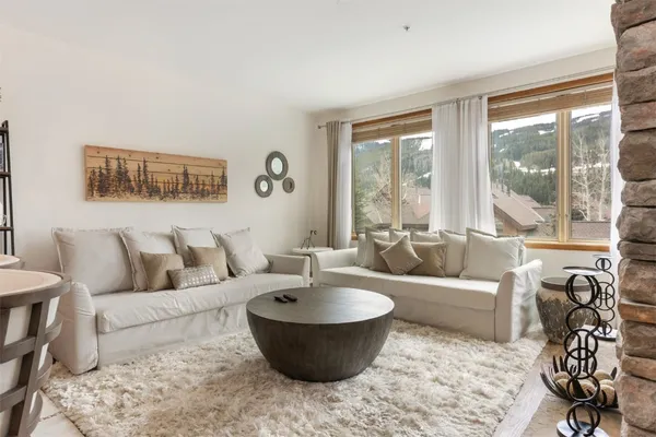 a living room with furniture and a large window