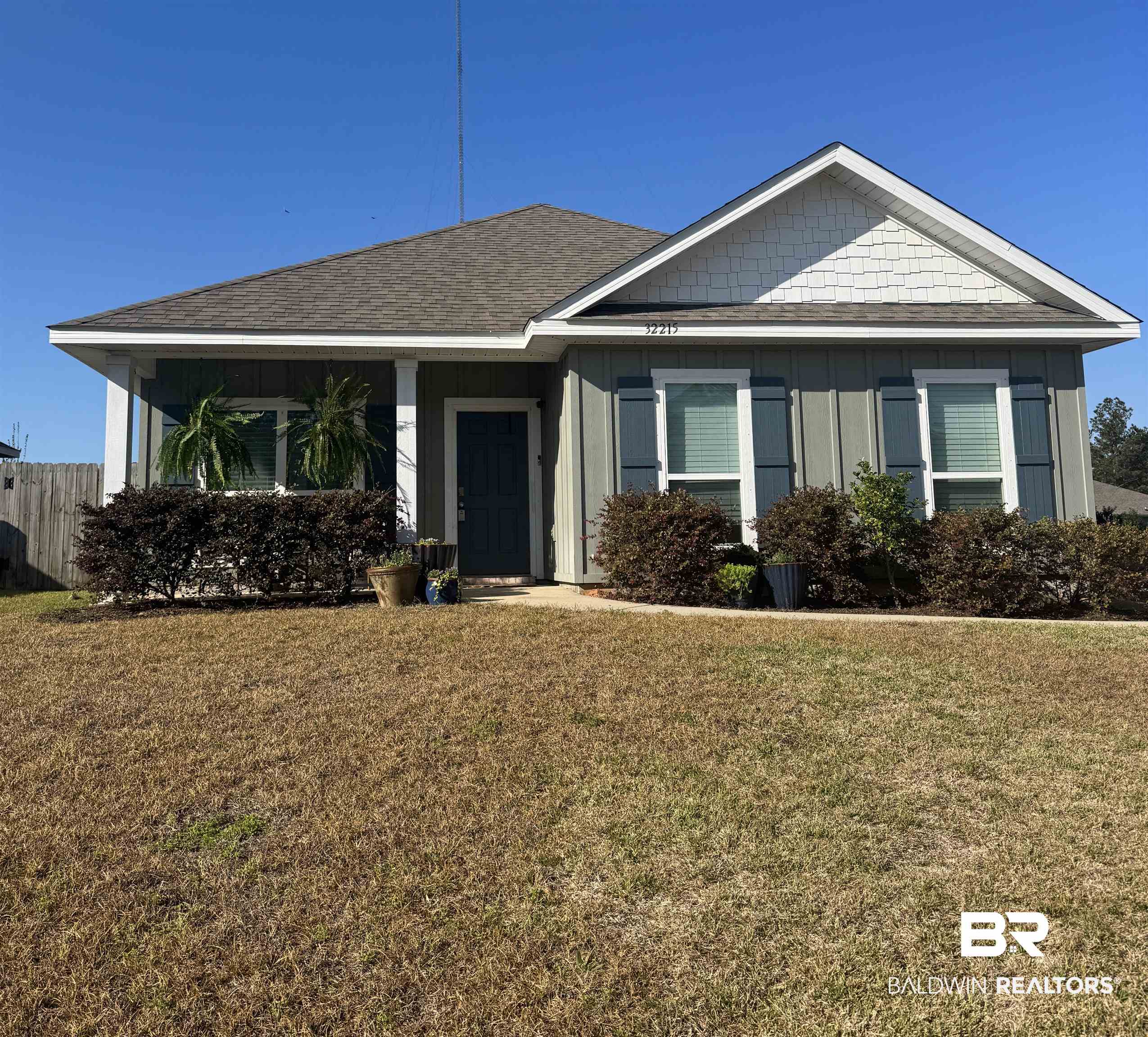 32215 Calder Court Daphne, AL 36527 - Photo 1 of 13 View of front facade with a front yard, a shingled roof, and board and batten siding