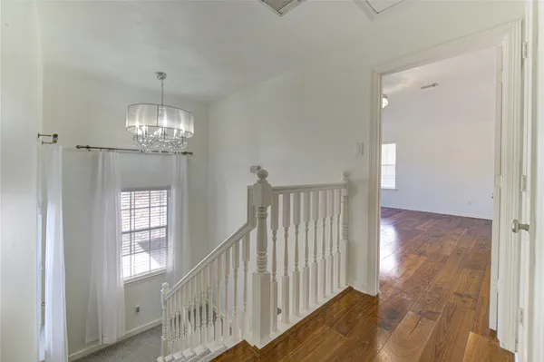 a view of a hallway view with wooden floor and staircase