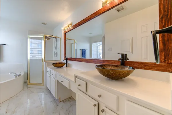 a bathroom with a double vanity sink and a bathtub