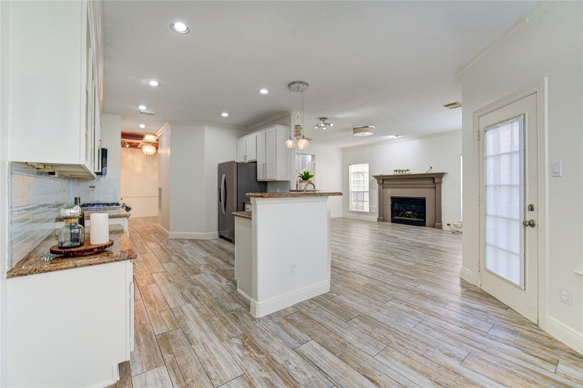 1115 Enclave Square East Houston, TX 77077 - Photo 7 of 42 Stainless steel appliances, including a built-in microwave and dishwasher, complement the contemporary look. The long counter layout provides plenty of workspace, while the wood-look tile flooring adds warmth and durability.