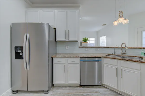 a kitchen with stainless steel appliances granite countertop a refrigerator sink and cabinets