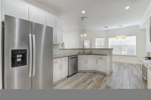 a kitchen with a refrigerator and a sink