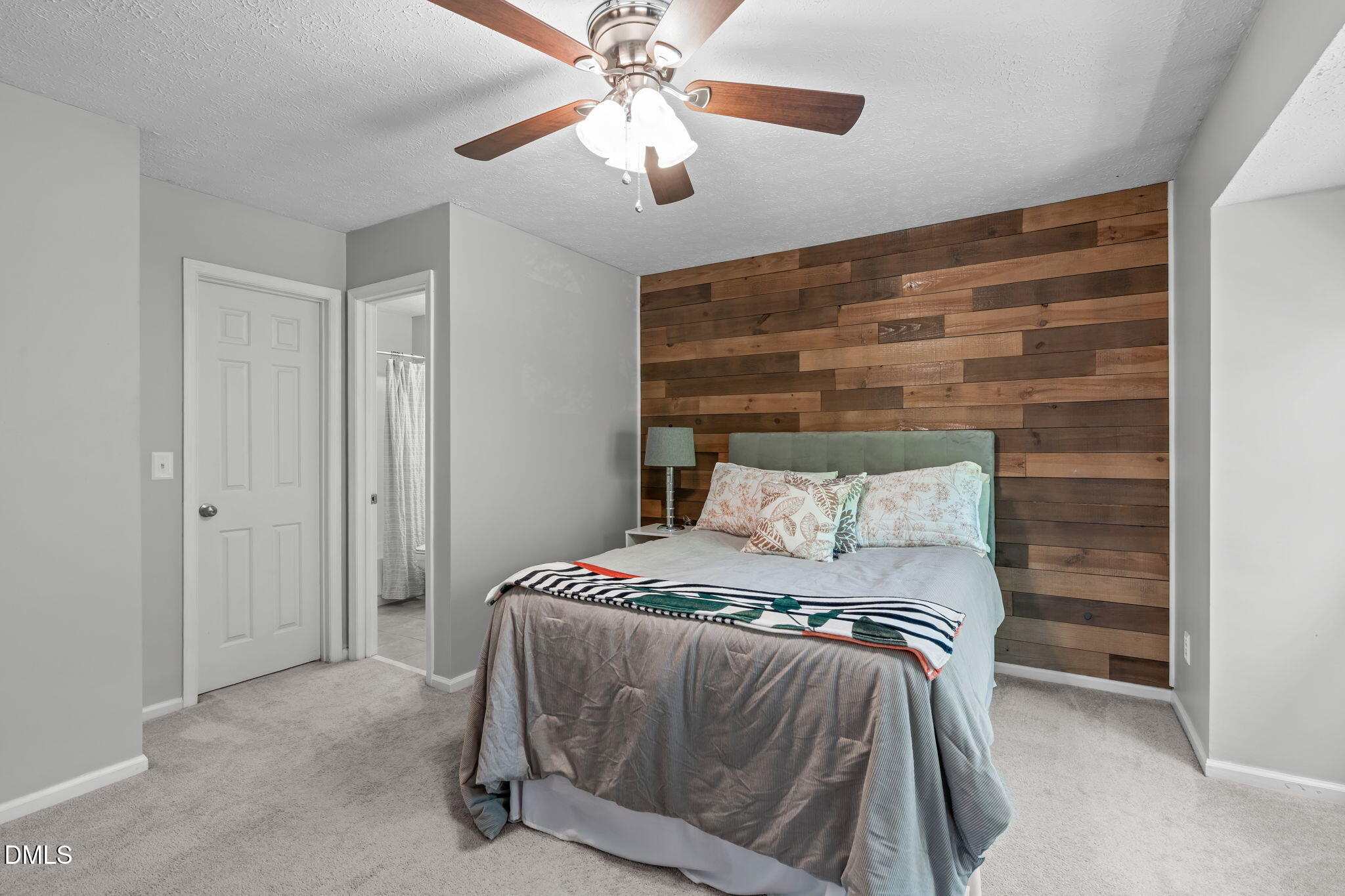 203 Oak Hollow Court Raleigh, NC 27613 - Photo 21 of 37 a bedroom with a bed and a chandelier