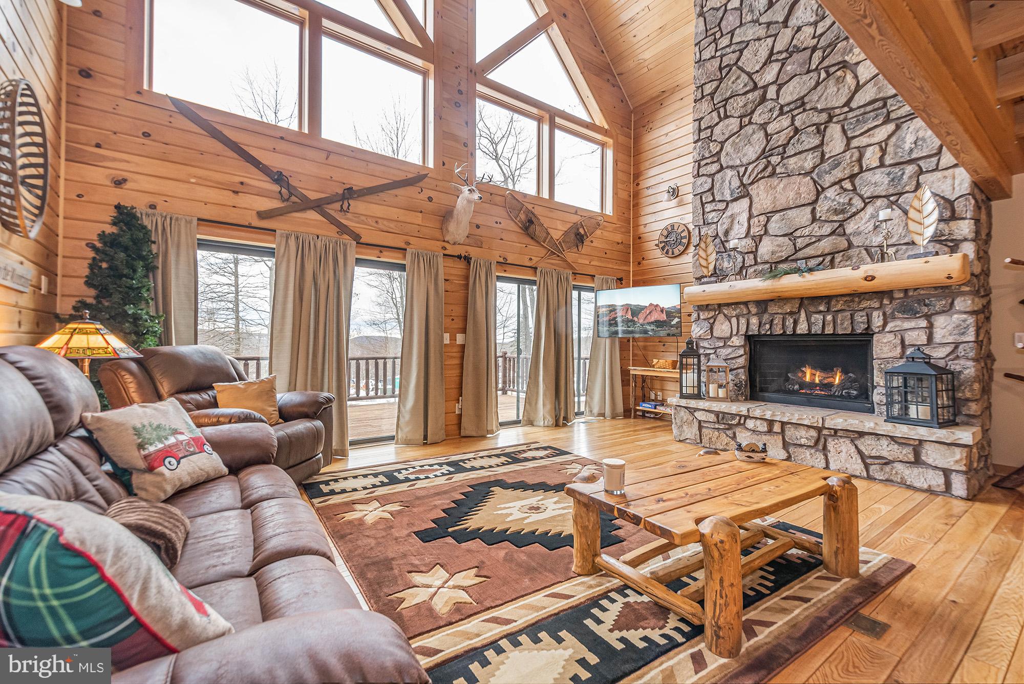 642 Deep Creek Highlands Road McHenry, MD 21541 - Photo 12 of 59 a outdoor space with patio furniture and a fireplace